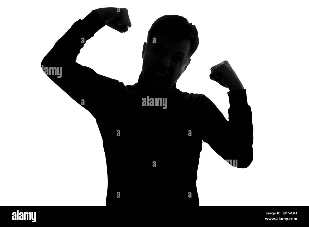 Man showing arms muscles smiling proud. Fitness concept. silhouette view Stock Photo