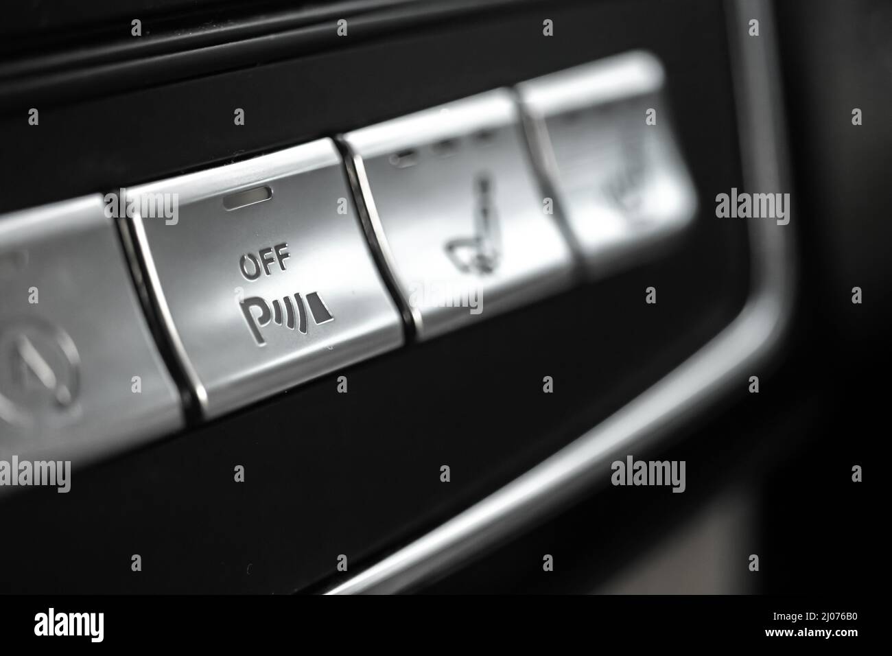 Car parking assist button inside luxury car interior closeup view