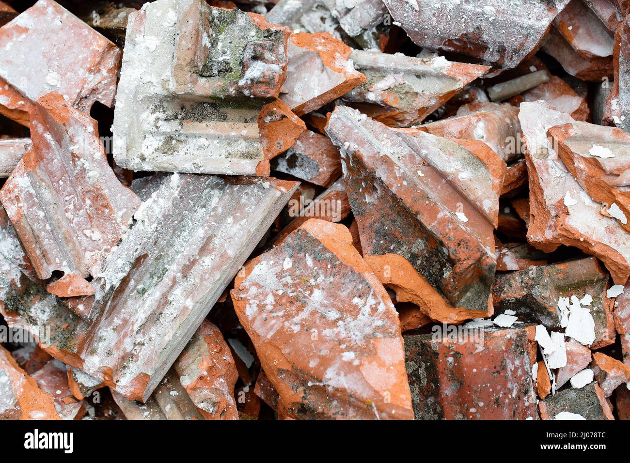 Close up of a heap of old, dirty broken roof tiles. Construction roofing industry background. Concept of renovation, demolition, earthquake or ecology Stock Photo
