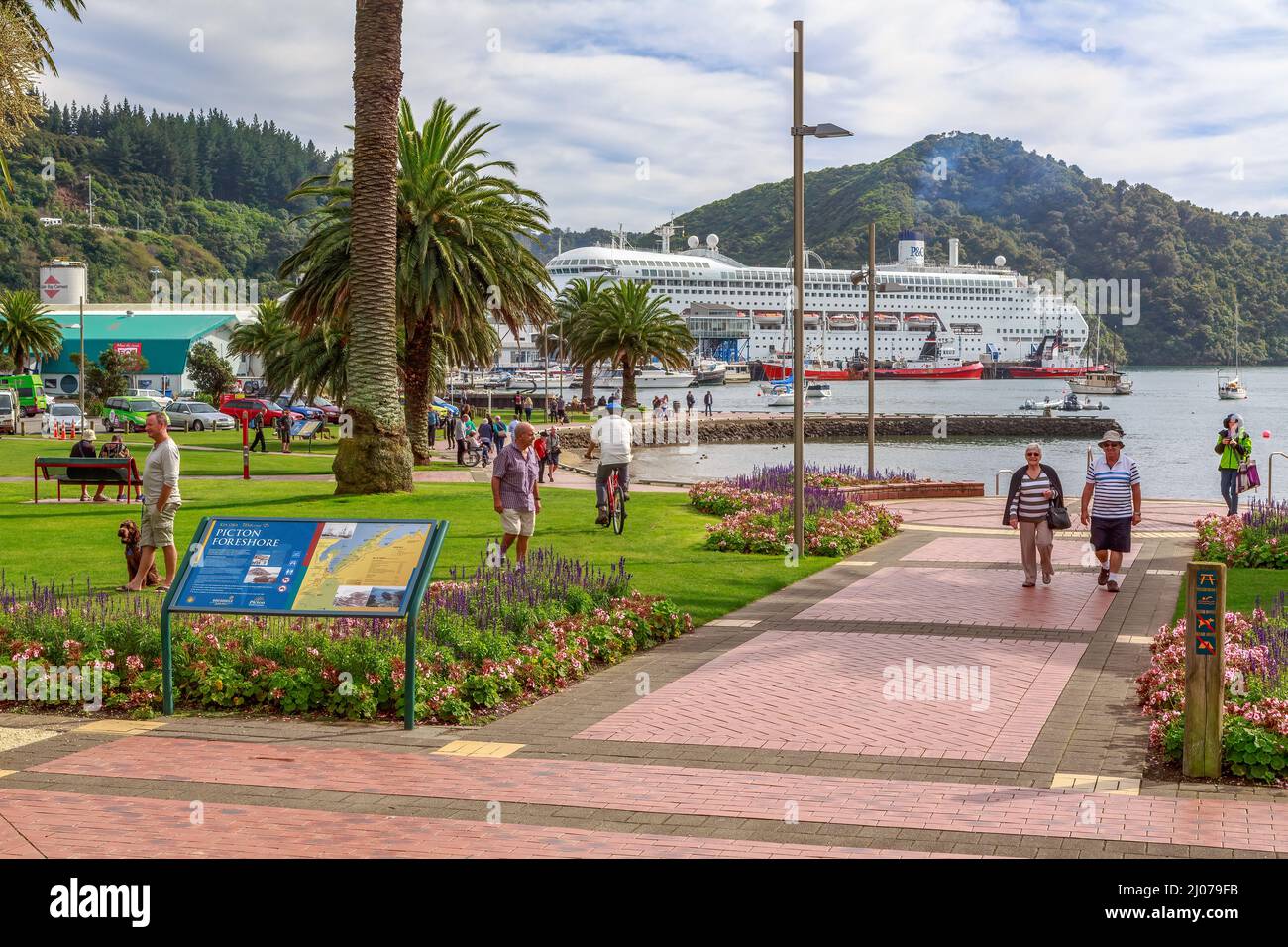 A waterfront park in Picton, a town in the South Island of New Zealand. A cruise ship is in port Stock Photo