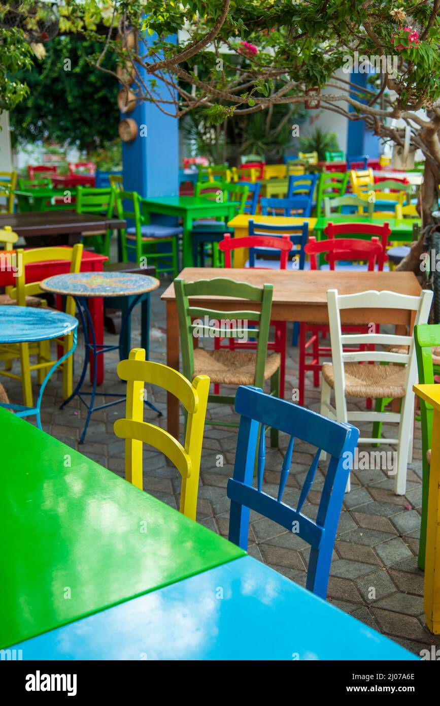 Table And Rural Chairs In Greek Outdoor Restaurant With Turquoise