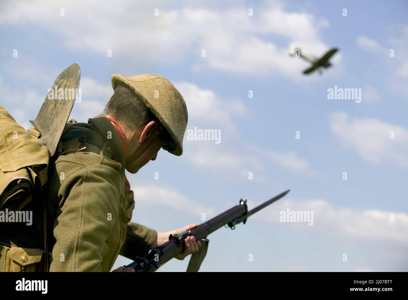 World War 1 British soldier shooting a German plane in battle reenactment in UK Stock Photo