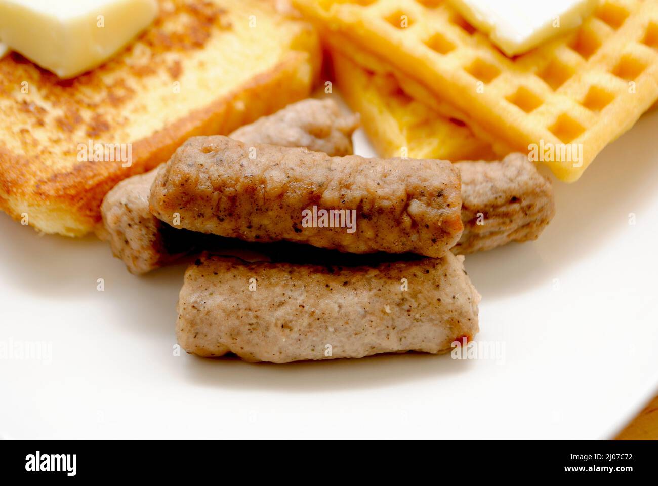 Close-Up of Cooked Breakfast Sausage Links Served on a Plate with Other Breakfast Foods Stock Photo