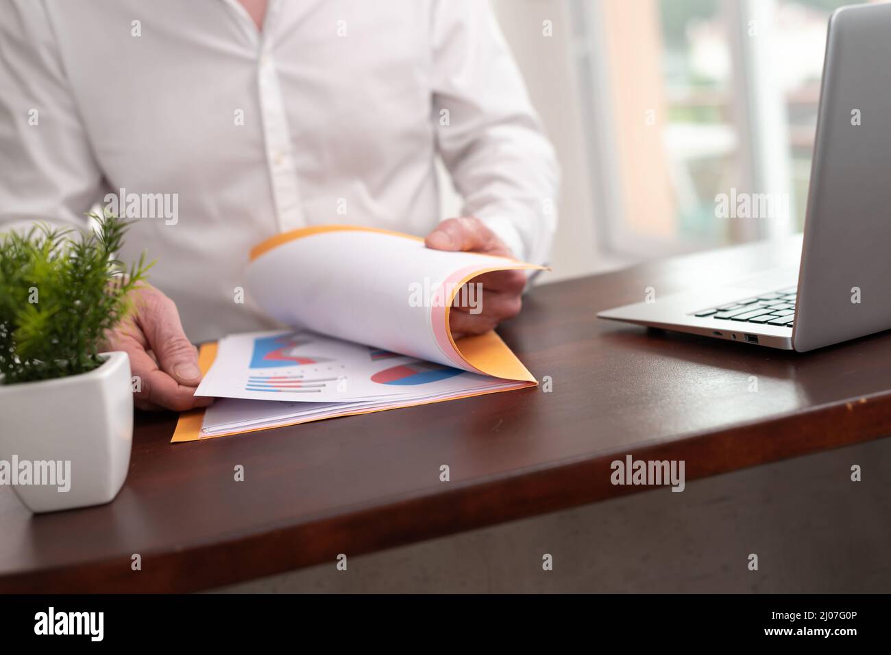 Businessman opening folder with paper documents Stock Photo - Alamy