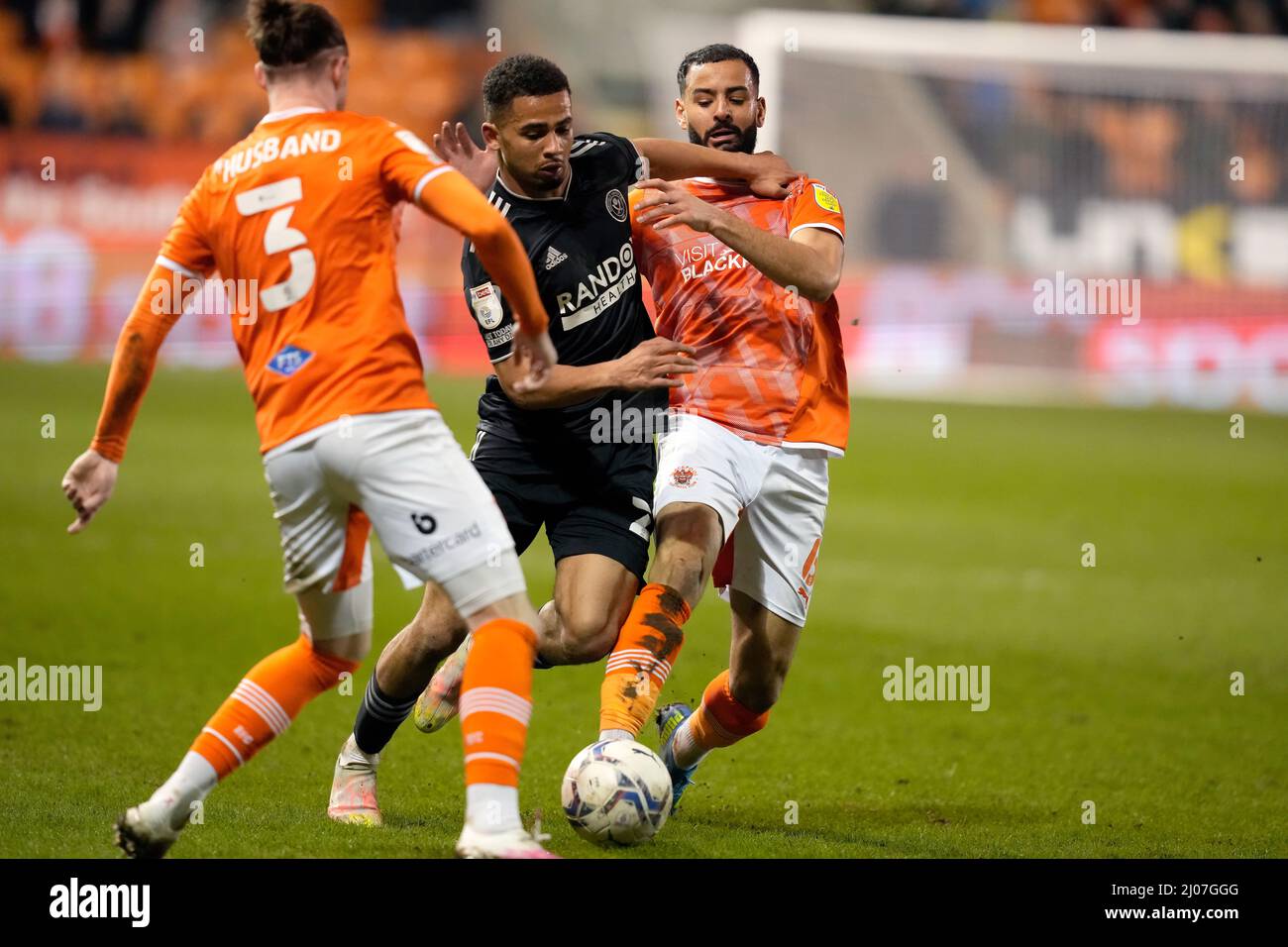 Blackpool, England, 16th March 2022. lliman Ndiaye of Sheffield Utd (C) is challenged by Kevin Stewart of Blackpool (R) and James Husband of Blackpool during the Sky Bet Championship match at Bloomfield Road, Blackpool. Picture credit should read: Andrew Yates / Sportimage Credit: Sportimage/Alamy Live News Stock Photo