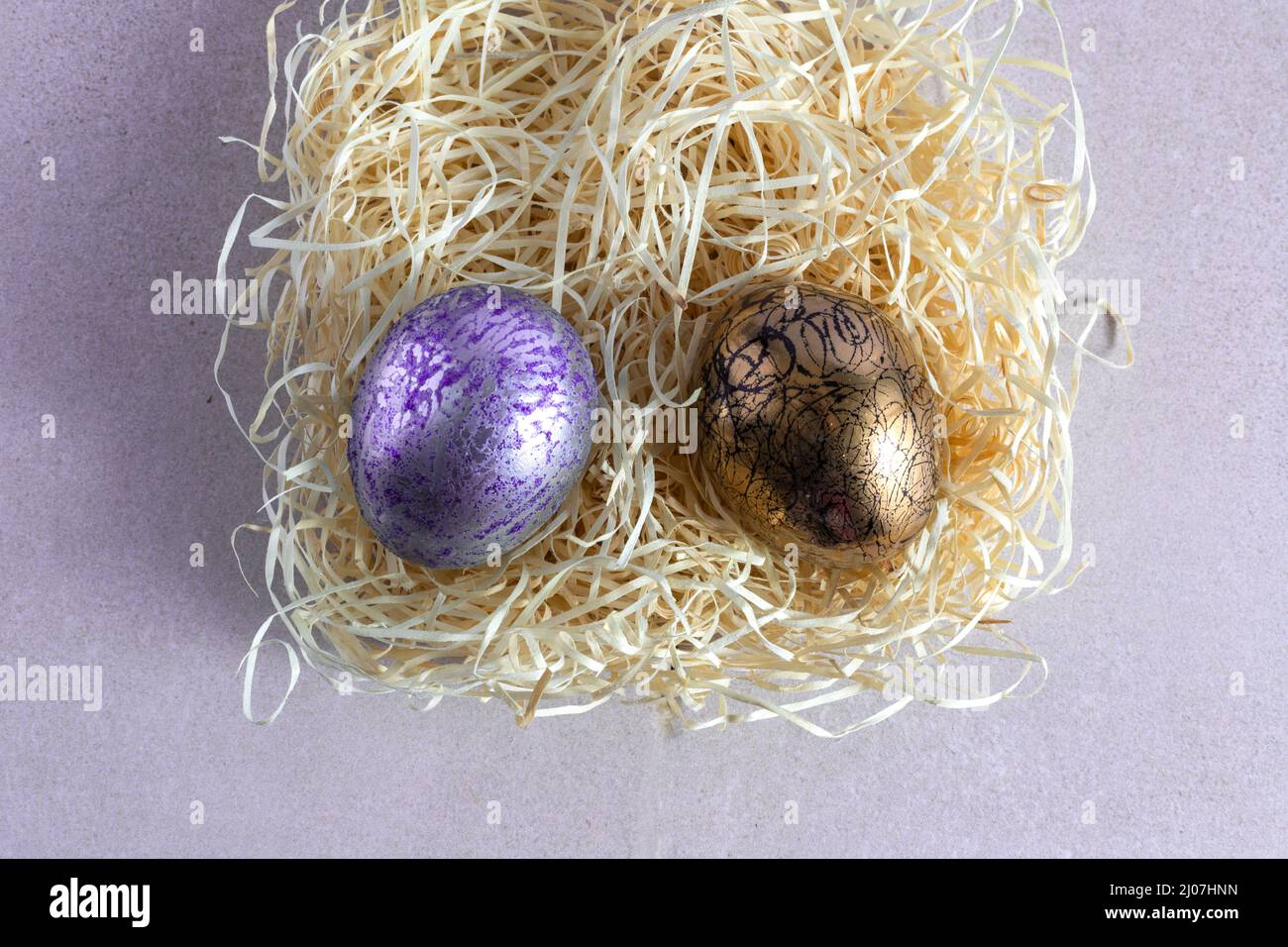Decorated and painted easter eggs in straw nest Stock Photo