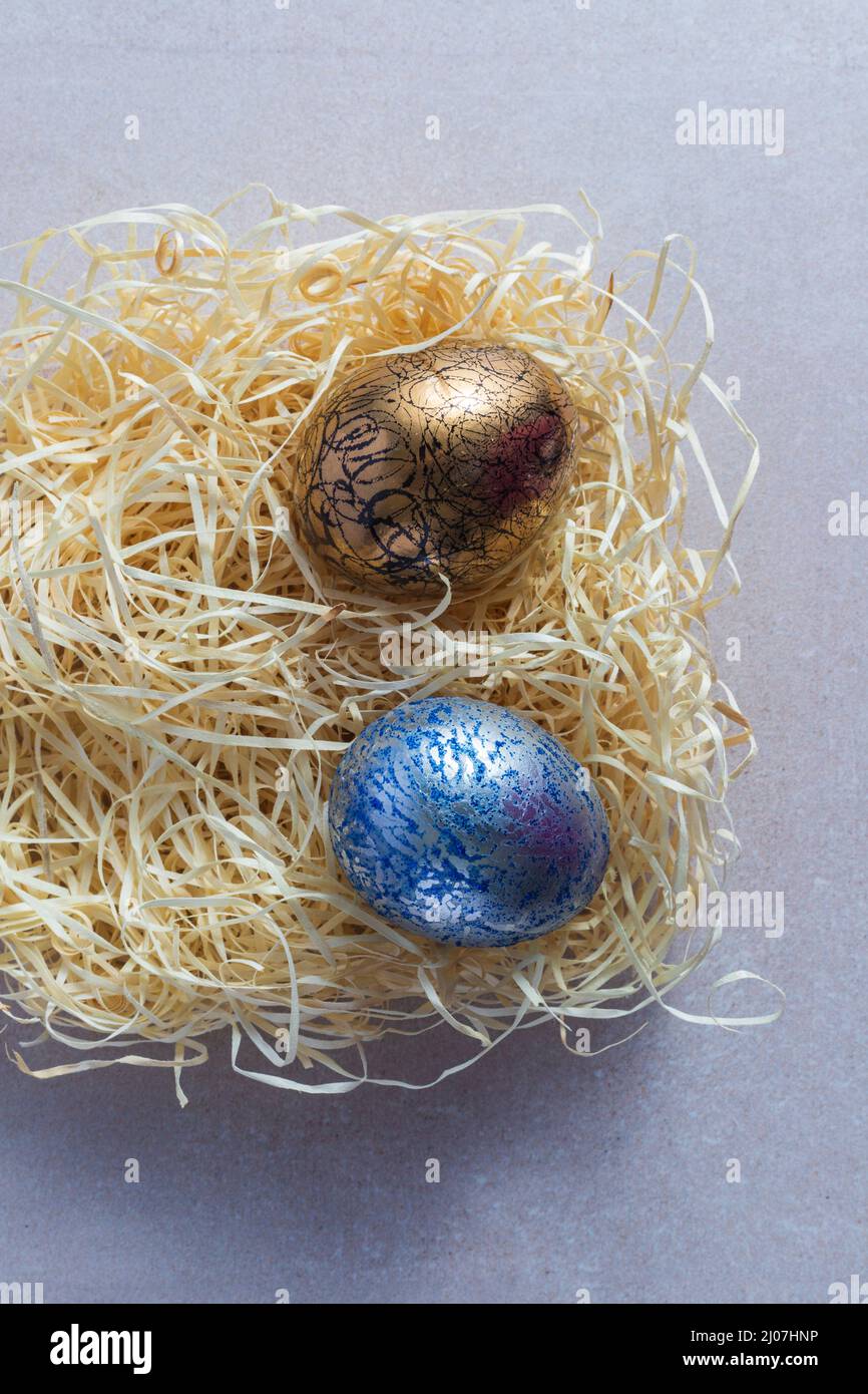 Decorated and painted easter eggs in straw nest Stock Photo