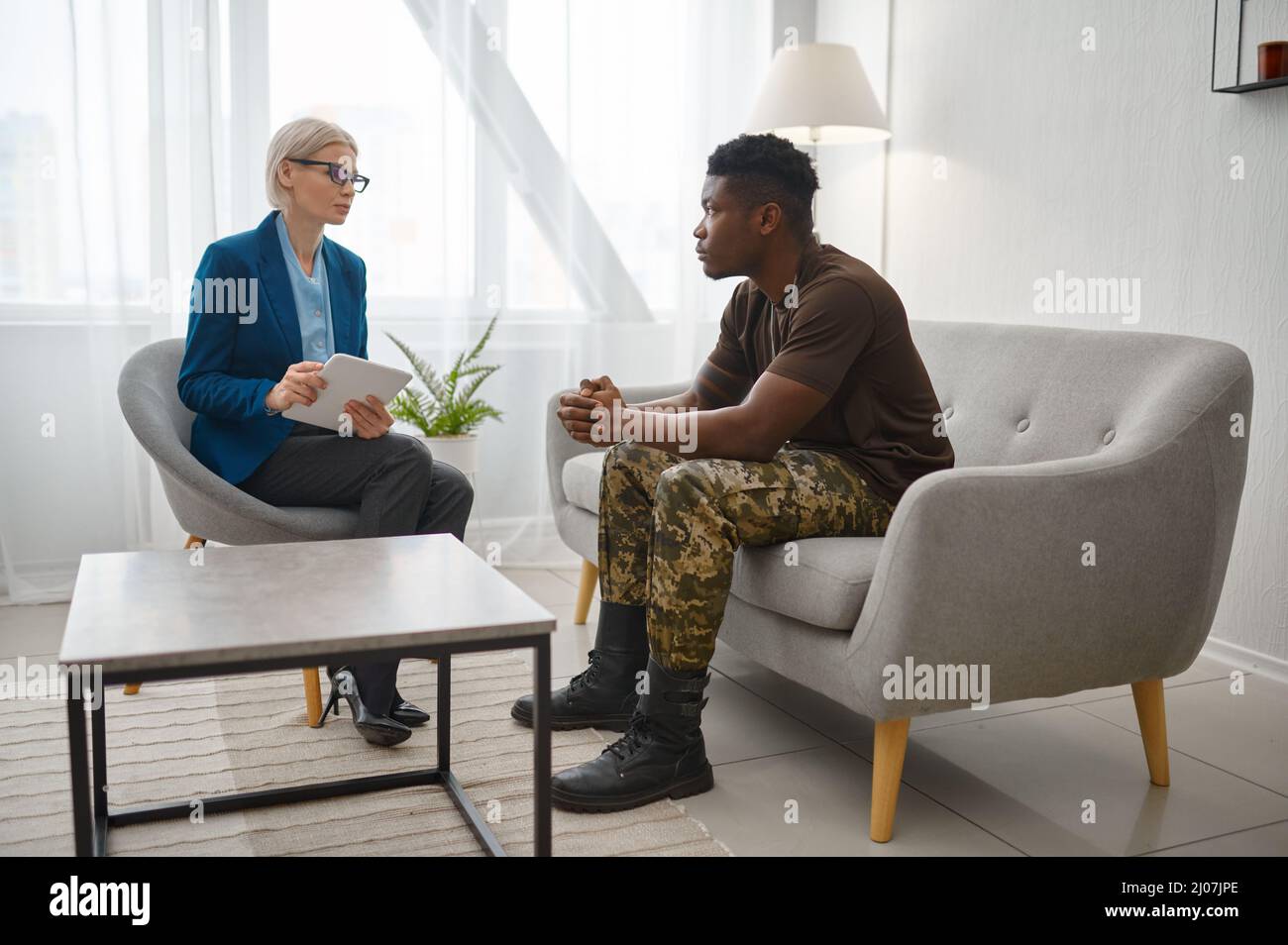 Soldier and psychotherapist during consultation Stock Photo