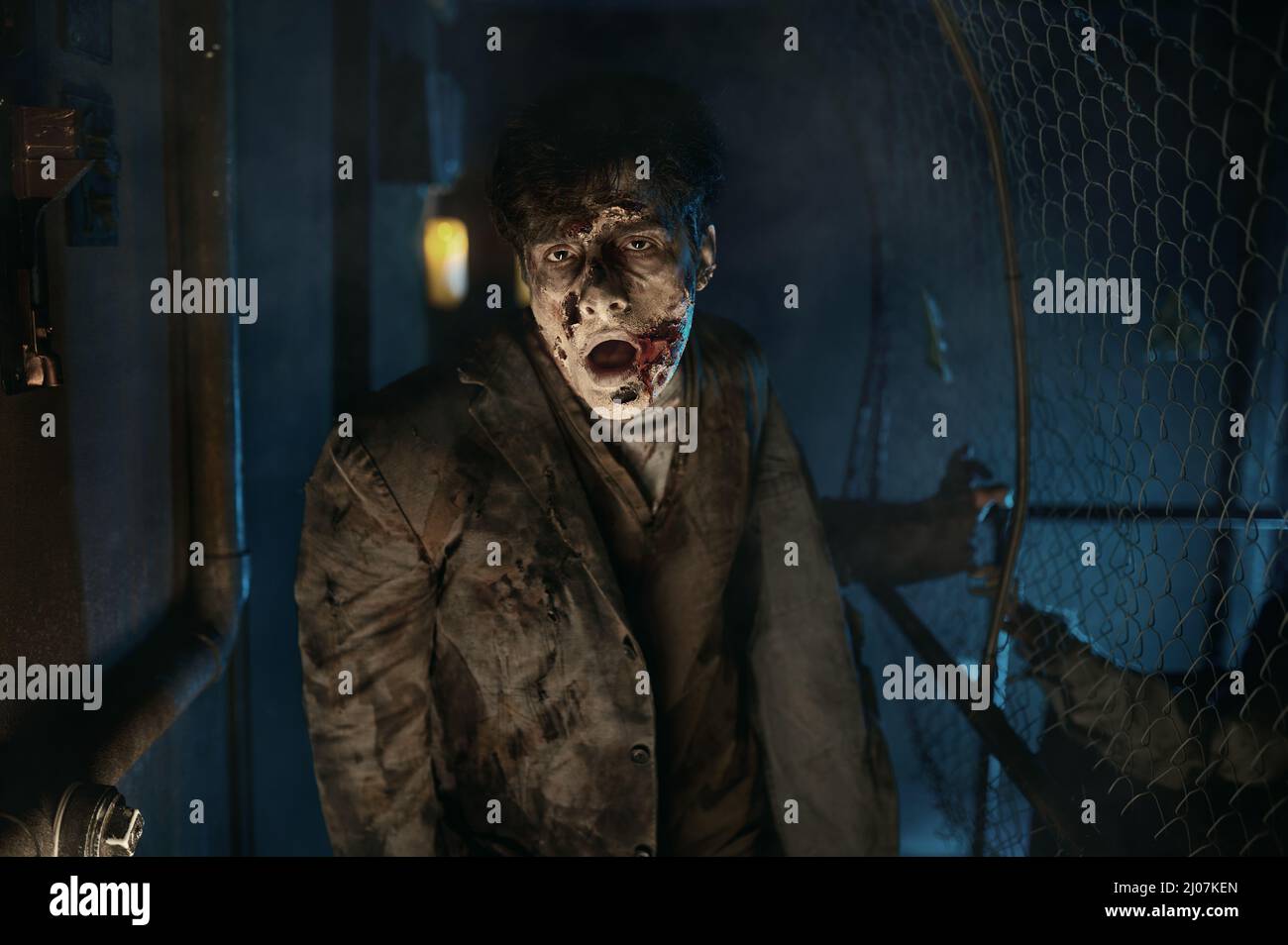 Insidious zombie looking for victim in house Stock Photo