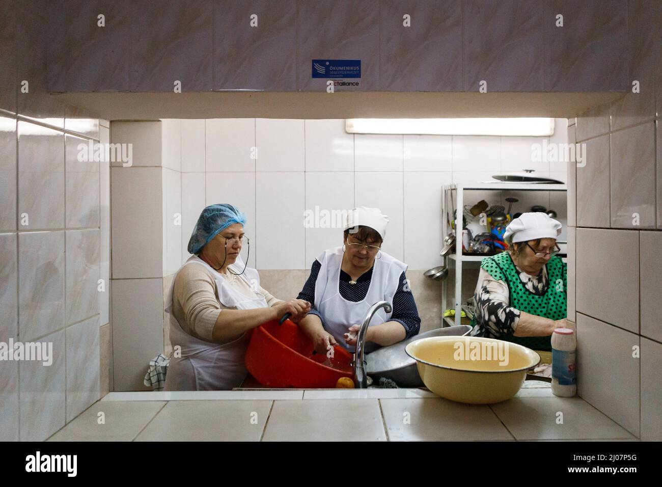 Women cook food in the kitchen of Gabriel Bethlen Berehove Lyceum that houses internally displaced persons, Berehove, Zakarpattia Region, western Ukraine, March 16, 2022. Photo by Serhii Hudak/Ukrinform/ABACAPRESS.COM Stock Photo
