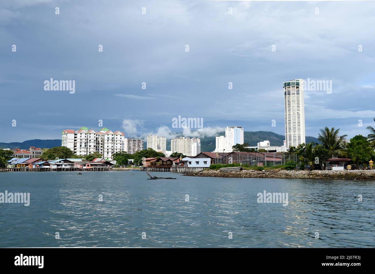 Georgetown, Penang, Malaysia - Oct 13 2017: KOMTAR building and old wooden stilt house and apartment, condo view from sea Stock Photo