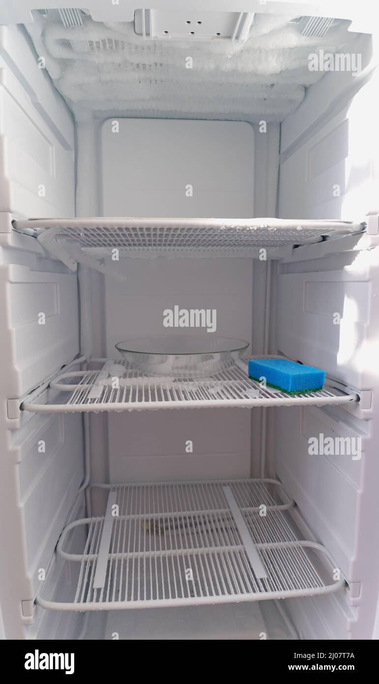 Defrosting of the home freezer. Freezer maintenance, defrosting, washing, repair. Stock Photo