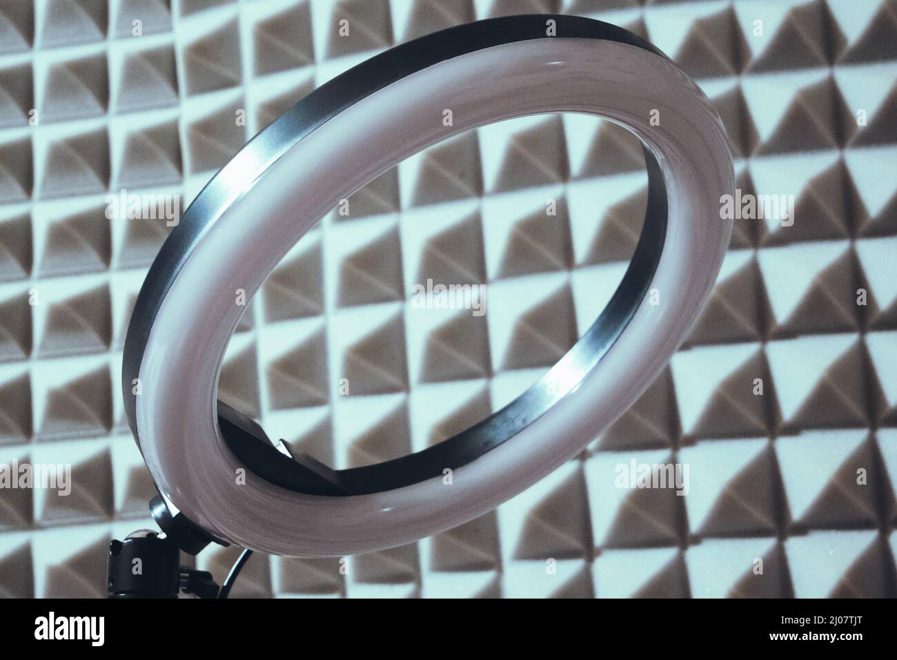 Ring RGB lamp on the background of sound-proof foam rubber. Stock Photo