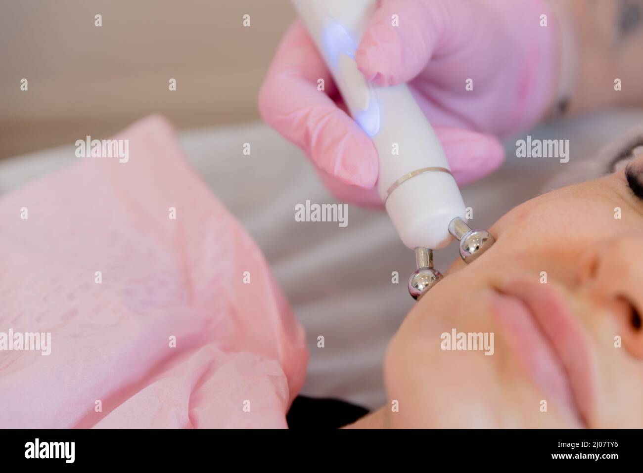 apparatus massager ultrasonic rf lifting in the hand of a beautician in a glove . Cosmetic apparatus for lifting and mesotherapy. Stock Photo