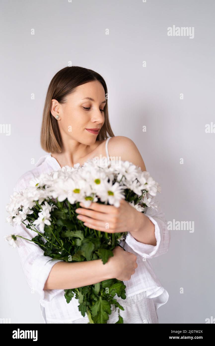 Young beautiful cute sweet lovely smiling woman with hold a bouquet of ...