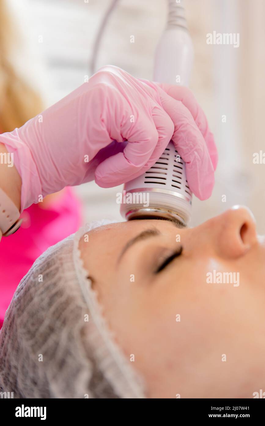 Hardware mesotherapy for the face. Dermapen apparatus photo. Cosmetology procedures. Cosmetic apparatus for lifting and mesotherapy. . Stock Photo