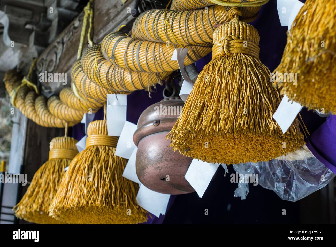 Close up detail of a large Japanese twisted straw rope with hanging