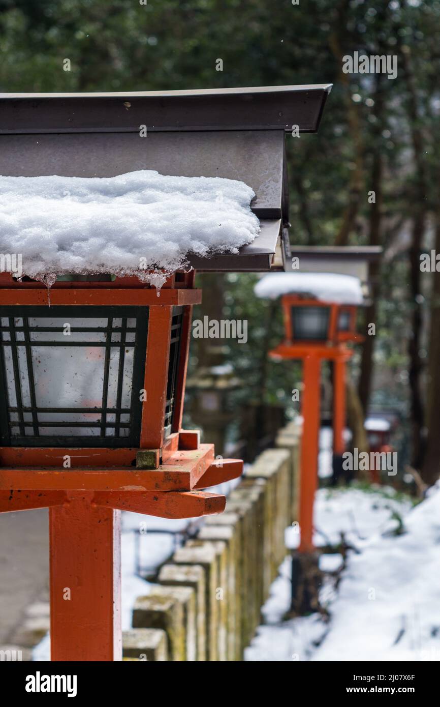 Traditional Japanese wooden lantern covered in snow at Kurama-dera temple in Kyoto Japan Stock Photo