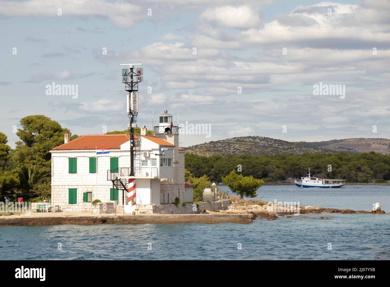 Sibenik, Croatia - August 25, 2021: Lighthouse at the entrance to St. Anthony Channel which leads to the port of  Sibenik, build in 1871. by Austro-Hu Stock Photo