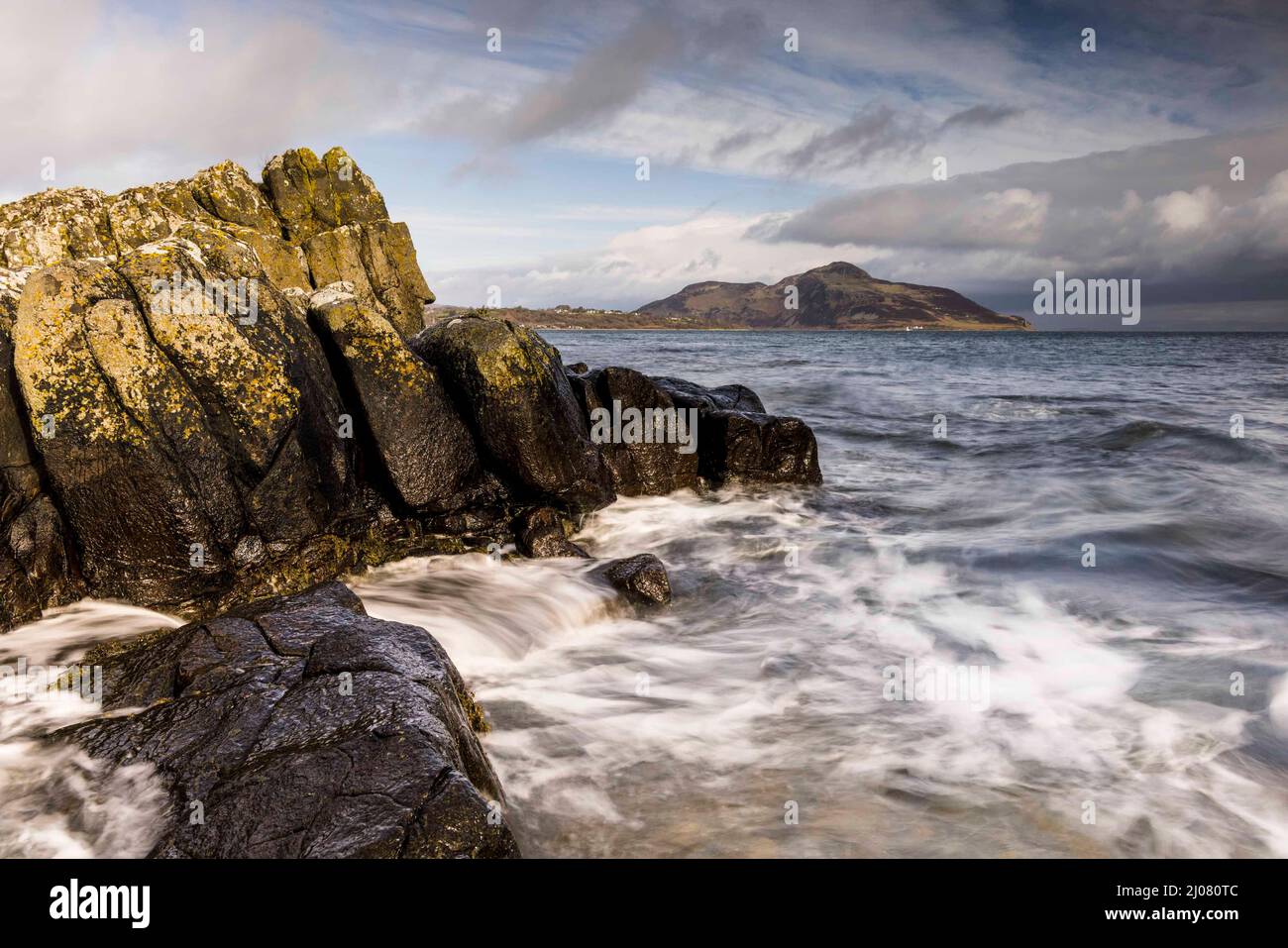 Isle of Arran, United Kingdom. 17 March, 2022 Pictured: Holy Island which is off the Isle of Arran from the shoreline of Whiting Bay. A mix of rain and sunshine throughout the day provides changeable conditions across Scotland. Credit: Rich Dyson/Alamy Live News Stock Photo
