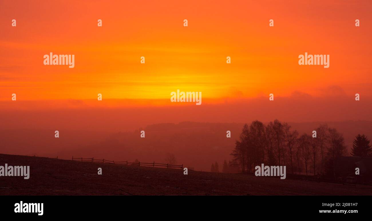 17 March 2022, Saxony, Bärenstein: Because of the Sahara dust in the air, the sky is reddish at sunrise. Photo: Oliver Kaufmann/promovie/dpa Stock Photo