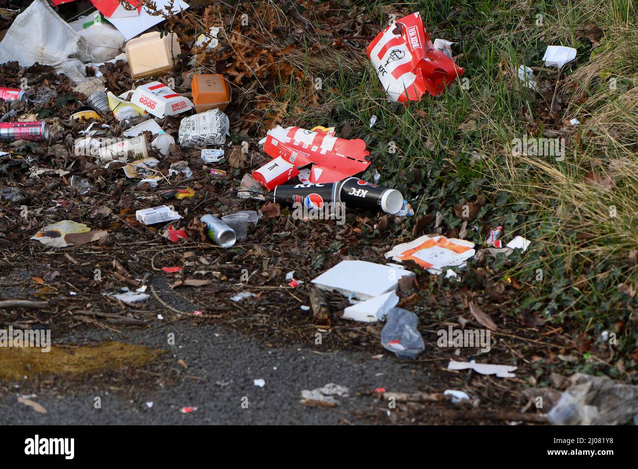 Fast food outlets Kentucky fried chicken and McDonalds waste littering a car park near the take-away restaurants in Southampton UK left by customers. Stock Photo