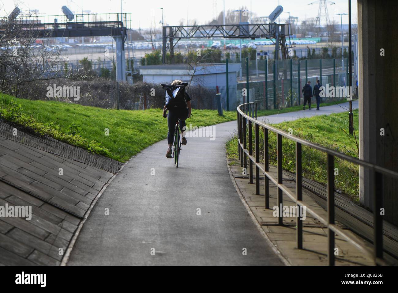 A single cyclist with a backpack using a underpass cycle route connecting Southampton City centre to the wider area outside of the city. Stock Photo