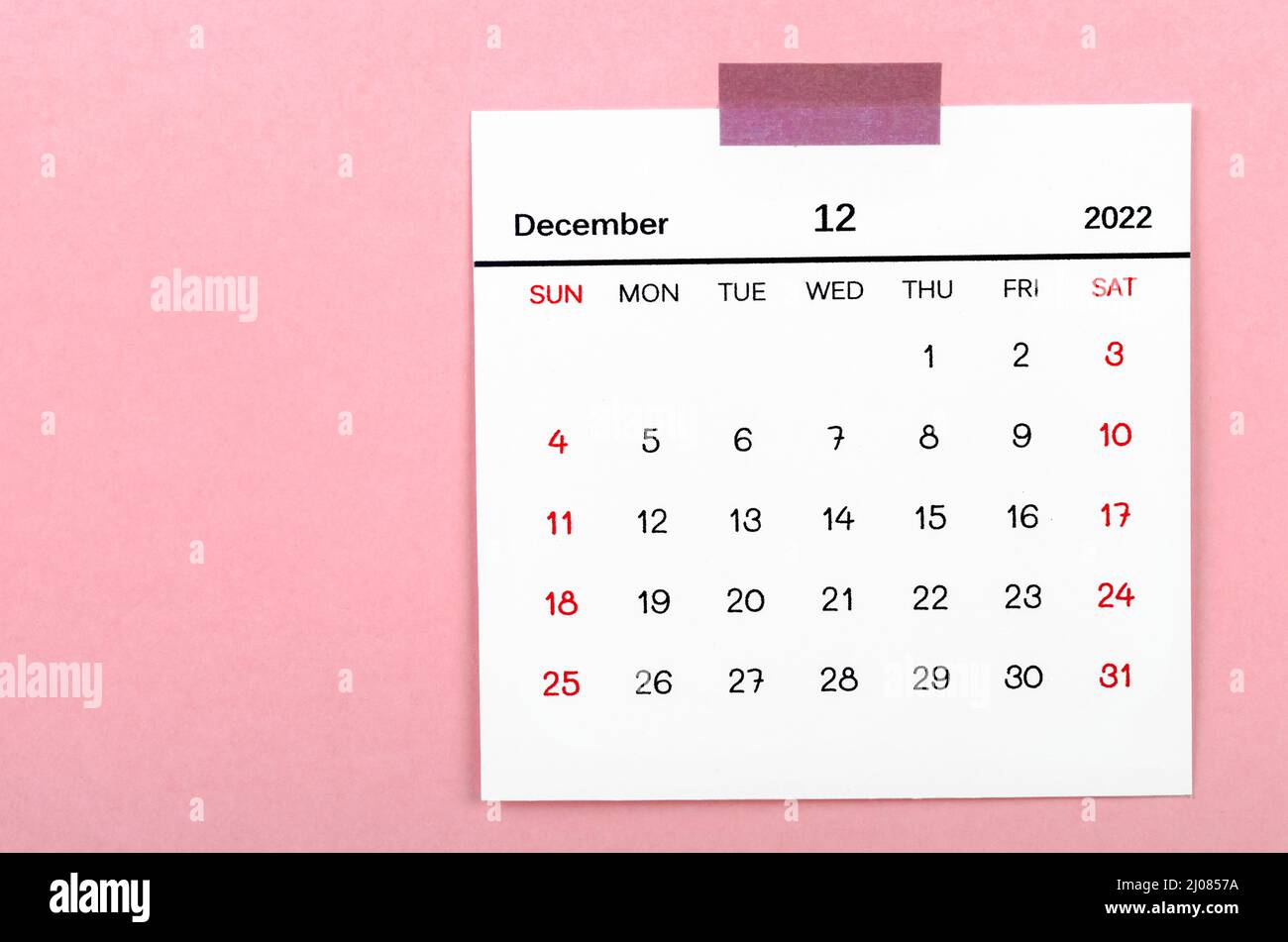 The December 2022 calendar on pink background. Stock Photo
