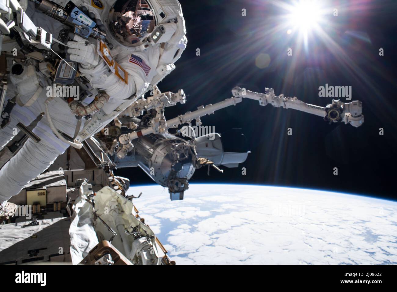 International Space Station, Earth Orbit. 15th Mar, 2022. International Space Station, EARTH ORBIT. 15 March, 2022. NASA astronaut Raja Chari, during a nearly 7 hour long spacewalk to prepare the International Space Station for the next roll-out solar array, March 15, 2022 in Earth Orbit. At right, are the SpaceX Crew Dragon Endurance docked to the Harmony module and the Canadarm2 robotic arm with the Pacific Ocean 262 miles below. Credit: NASA/NASA/Alamy Live News Stock Photo