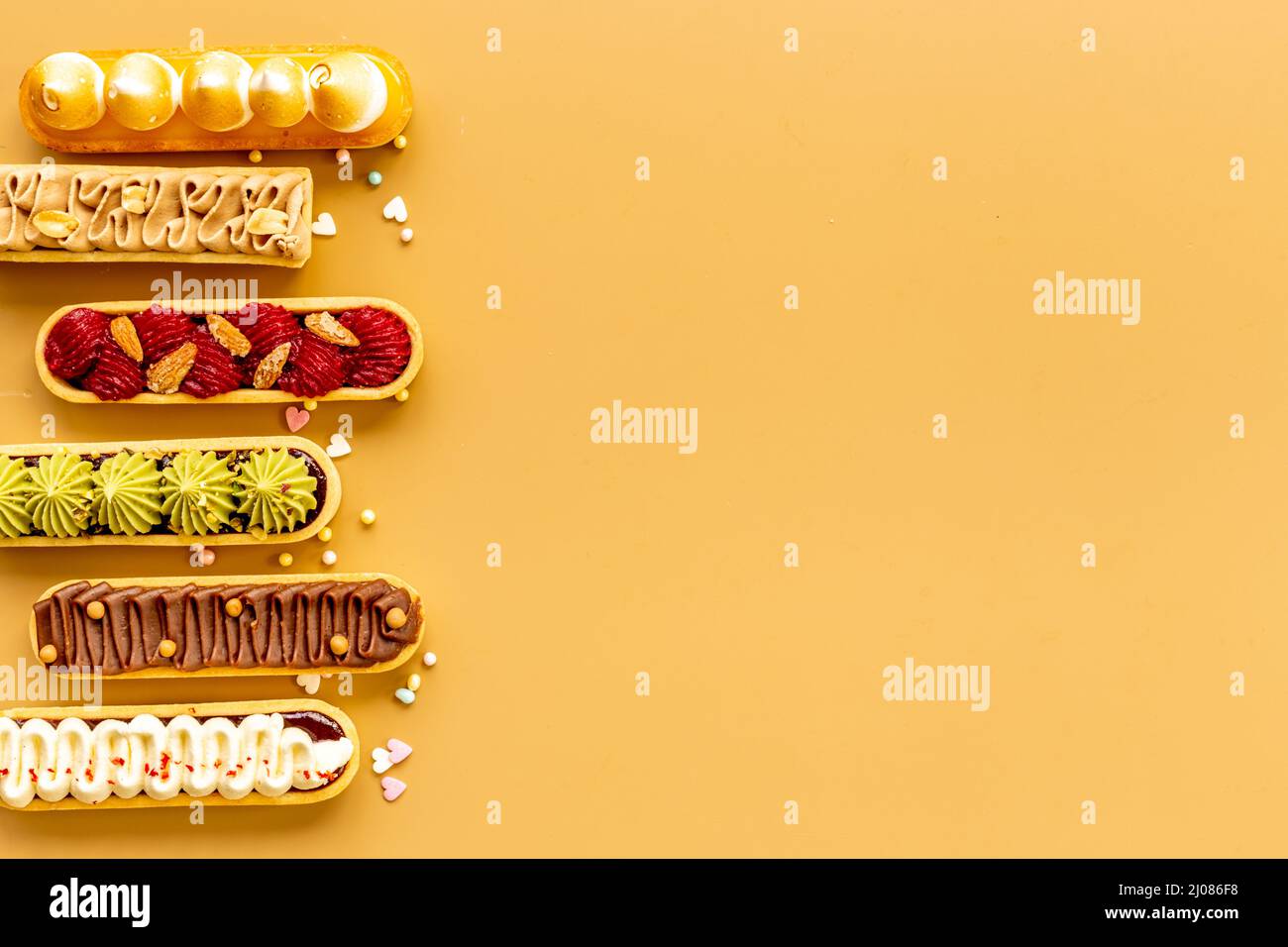 Flatlay of color eclairs with pistachio raspberries and chocolate Stock ...