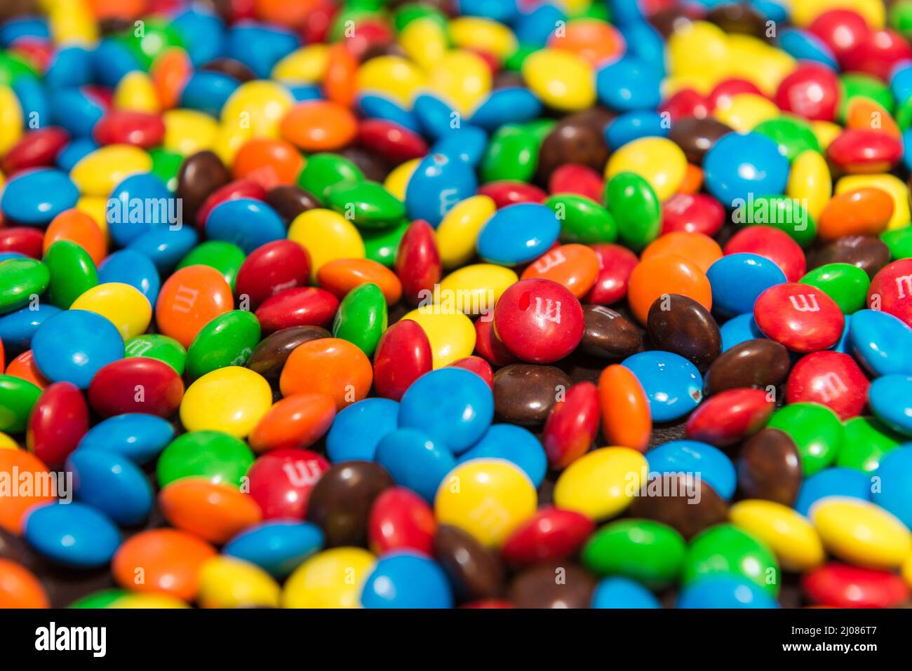 inner view of a birthday cake filled with colorful m&m and other candies Stock Photo