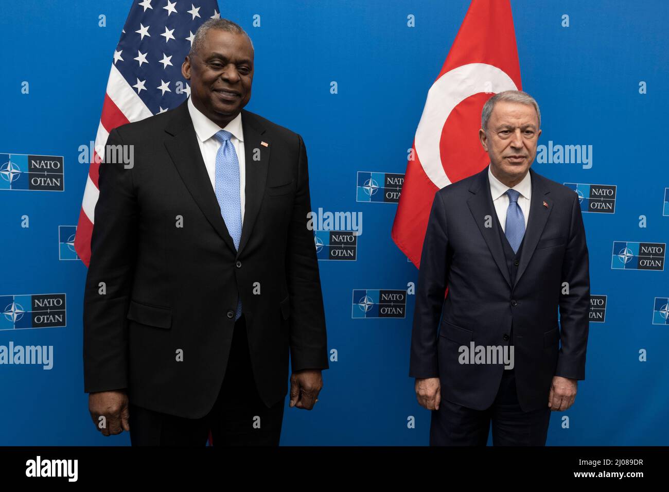 Brussels, Belgium. 16th Mar, 2022. U.S. Secretary of Defense Lloyd J. Austin III, left, stands with Turkish Minister of National Defence Hulusi Akar on the sidelines of the defense ministerial meetings at NATO headquarters, March 16, 2022 in Brussels, Belgium. The meetings are to discuss the Russian invasion of Ukraine. Credit: Chad J. McNeeley/DOD/Alamy Live News Stock Photo