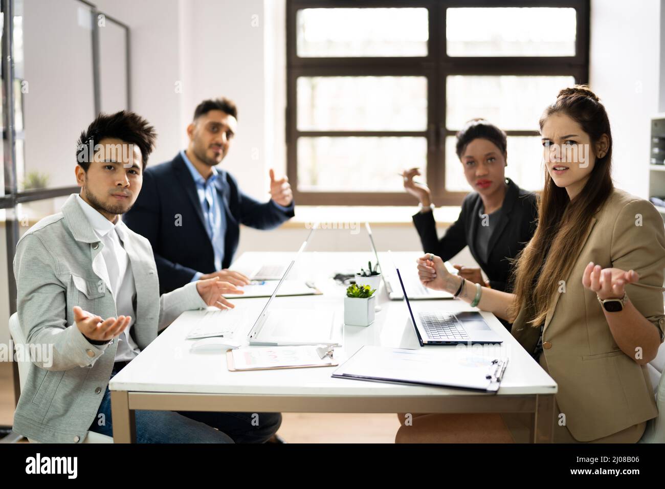 Angry Executives At Workplace Complaining. Worker Fight Stock Photo