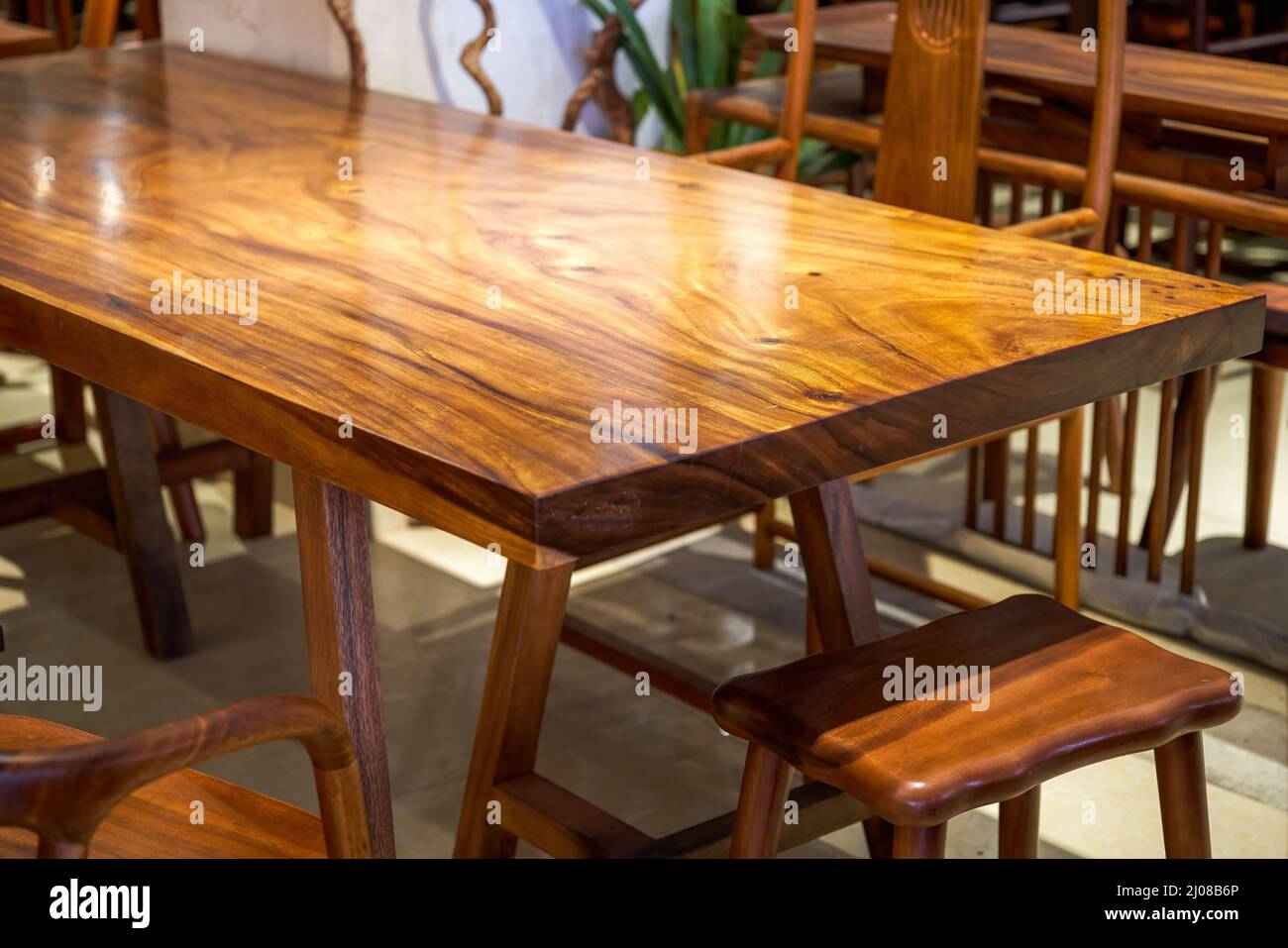 Mahogany planks and mahogany table tops for sale in the market Stock