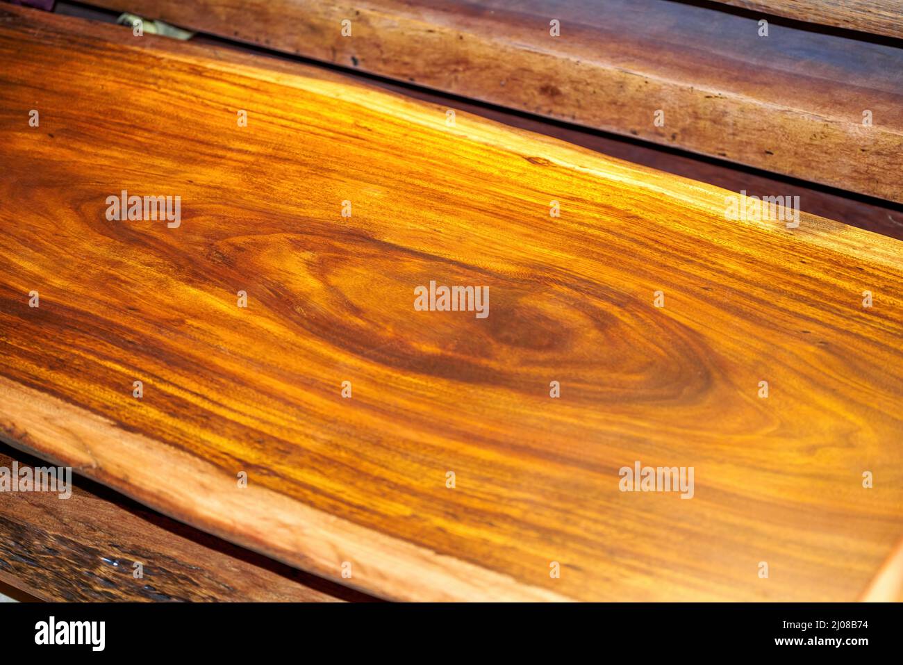 Mahogany planks and mahogany table tops for sale in the market Stock