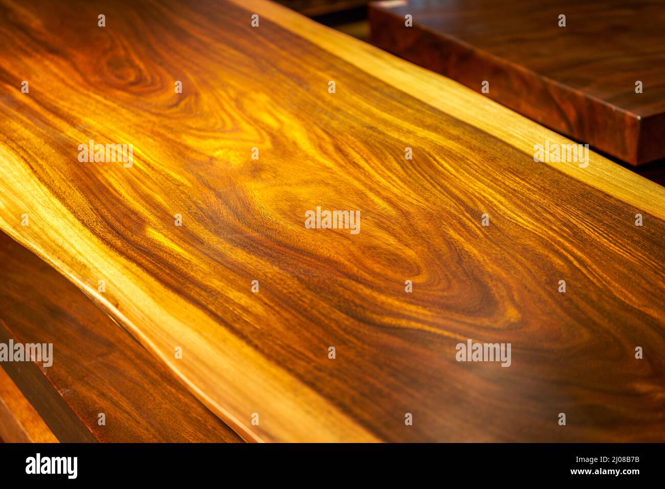 Mahogany planks and mahogany table tops for sale in the market Stock