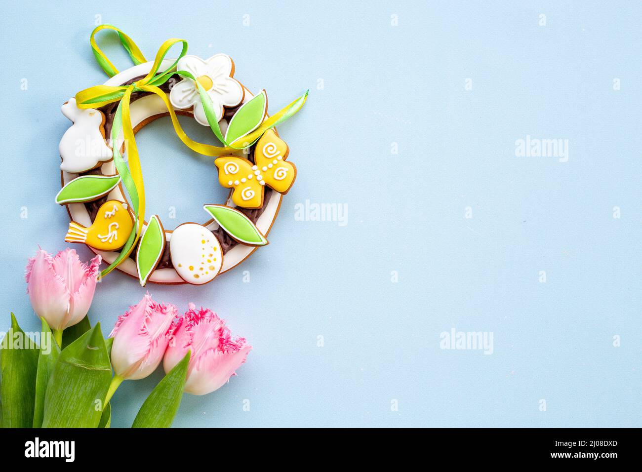 Happy Easter with pink tulips and cookies. Easter background Stock Photo