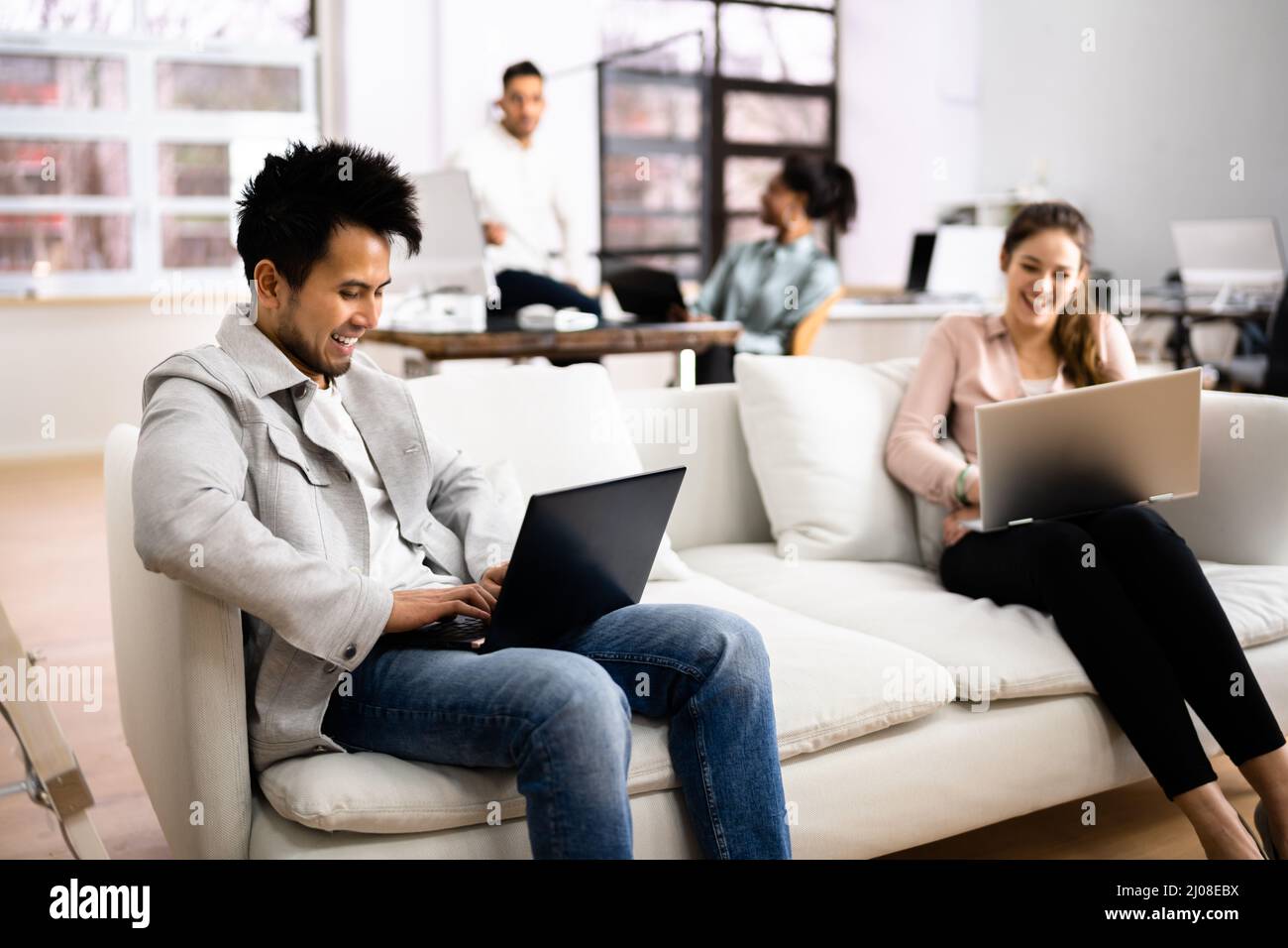 Young Diverse People Working In Coliving Space Stock Photo
