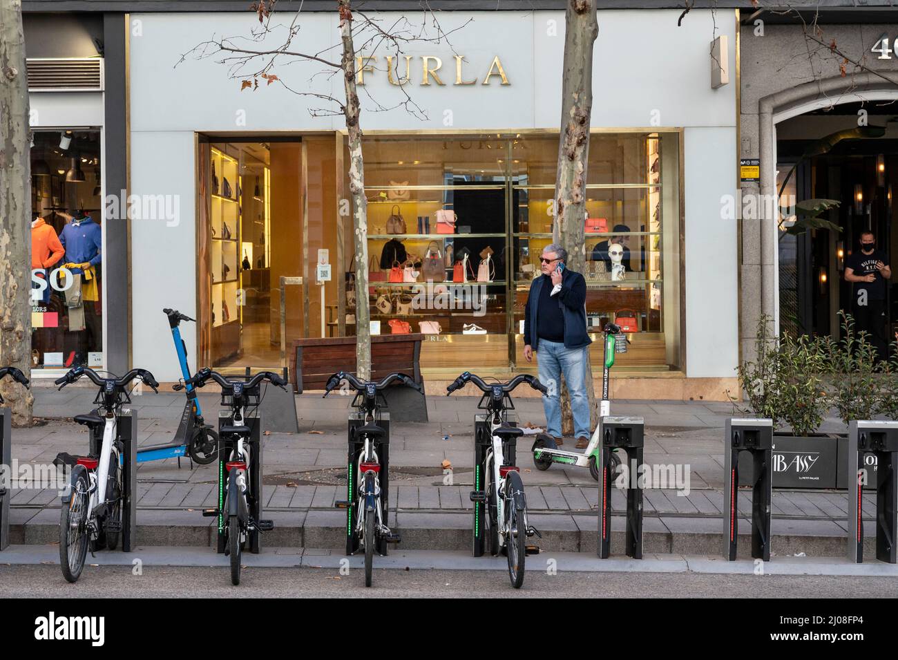 Madrid, Spain. 22nd Feb, 2022. A man talks on his phone in front of the Italian clothing luxury brand Furla store in Spain. (Credit Image: © Xavi Lopez/SOPA Images via ZUMA Press Wire) Stock Photo