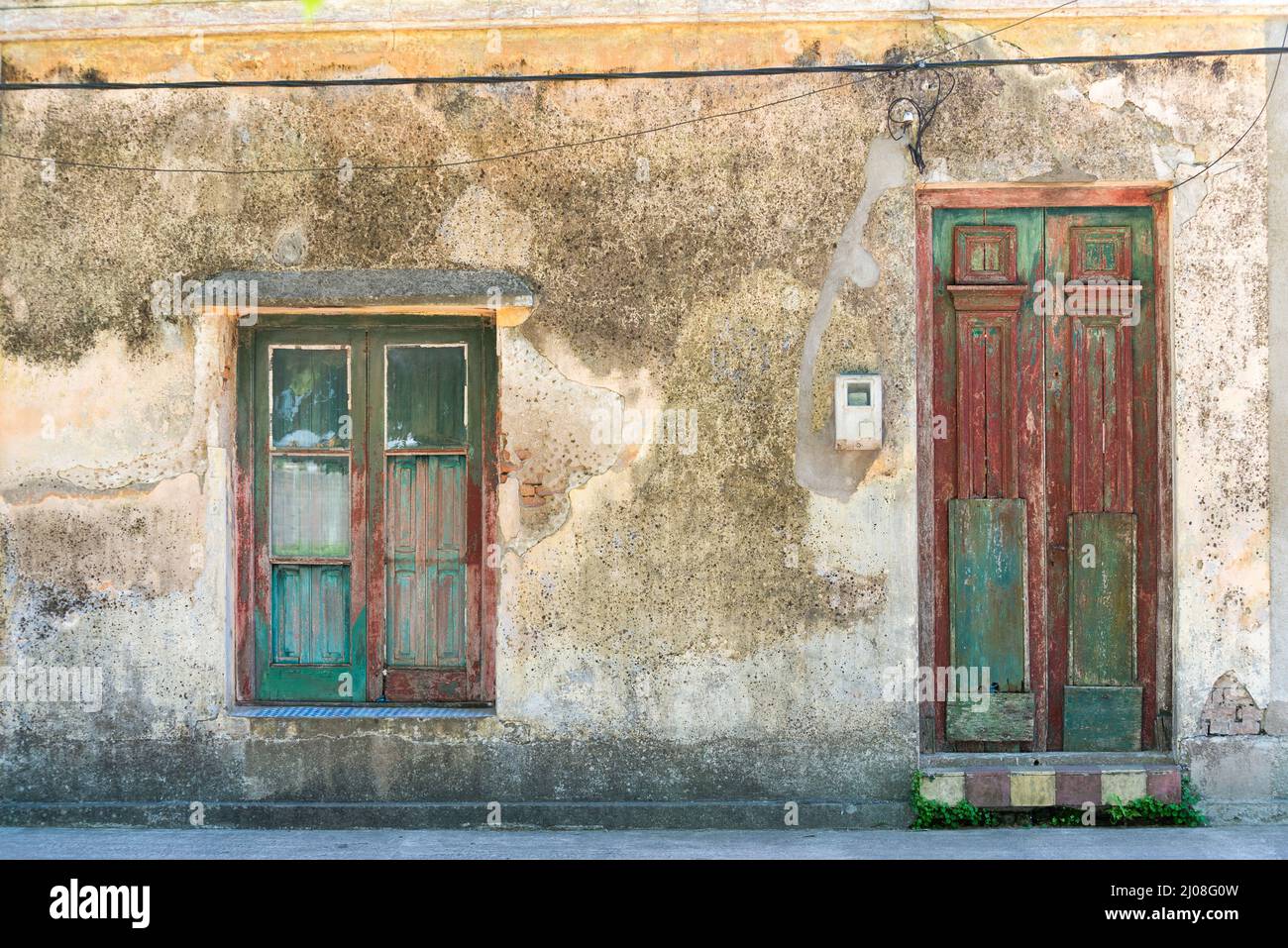 Old house facade  with wooden door and window at San Gregorio de Polanco, Tacuarembo, Uruguay Stock Photo