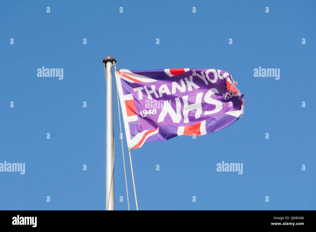 Thank You NHS flag fluttering in a bright blue sky, London, England, UK Stock Photo