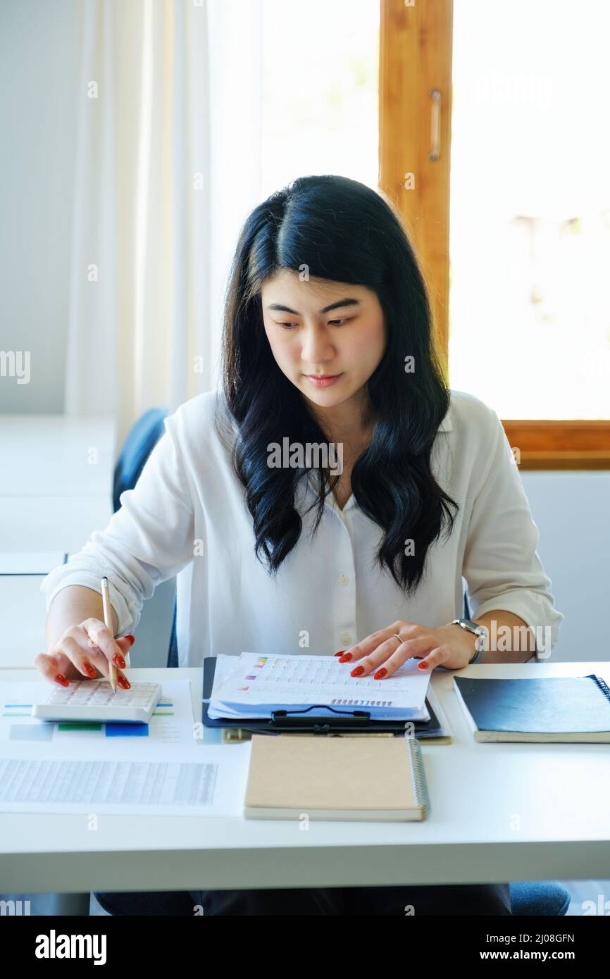 Concept auditors, financiers, female employees pressing calculators and ...