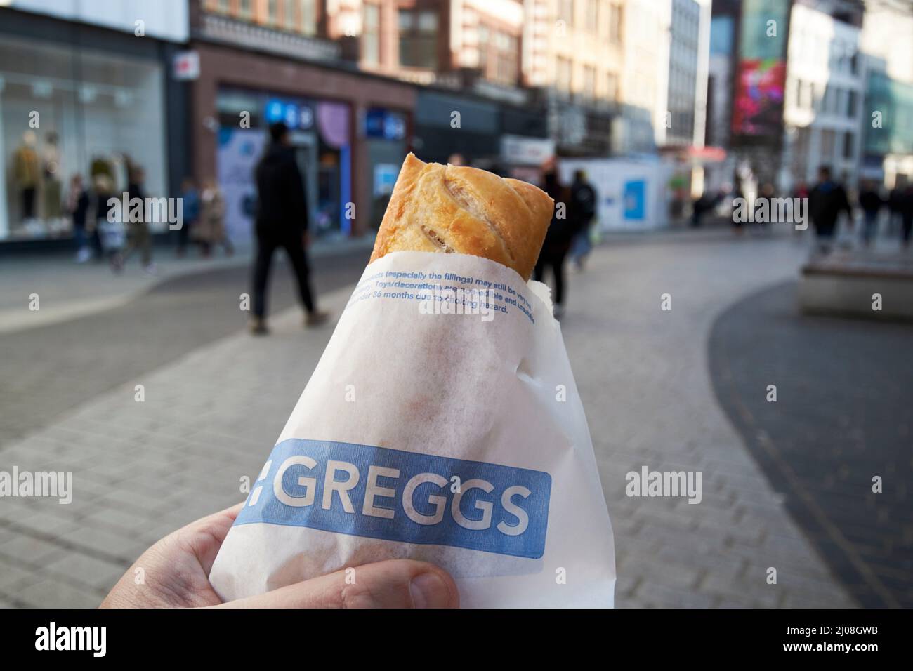 greggs sausage roll on the move in the city centre of liverpool, england, uk Stock Photo