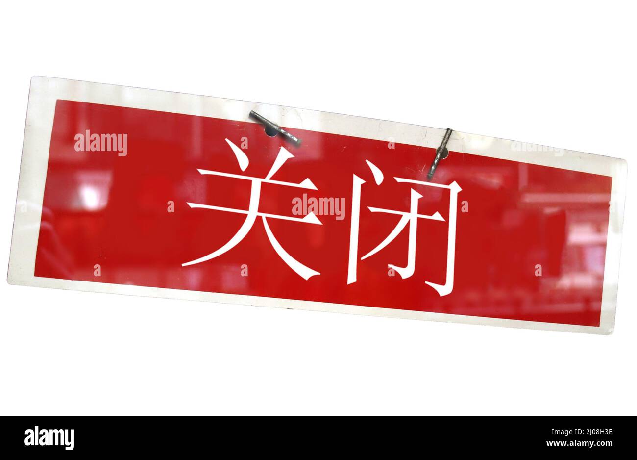 Closed sign in a shop window written in Chinese isolated over white ...