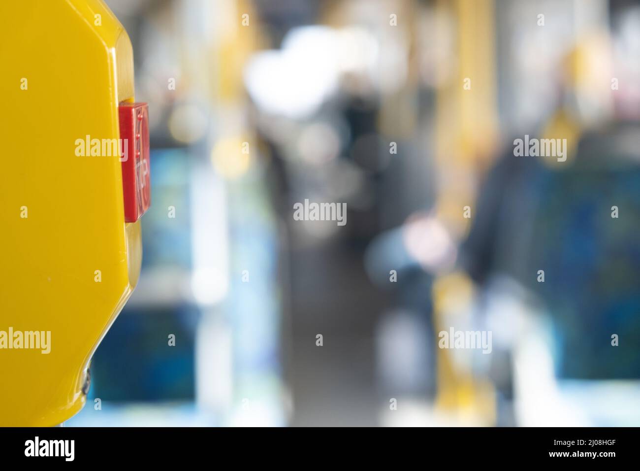 Stockholm / Sweden - MARCH 14, 2022: Closeup of a Hold request button on a bus with unfocus corridor in the background. Stock Photo
