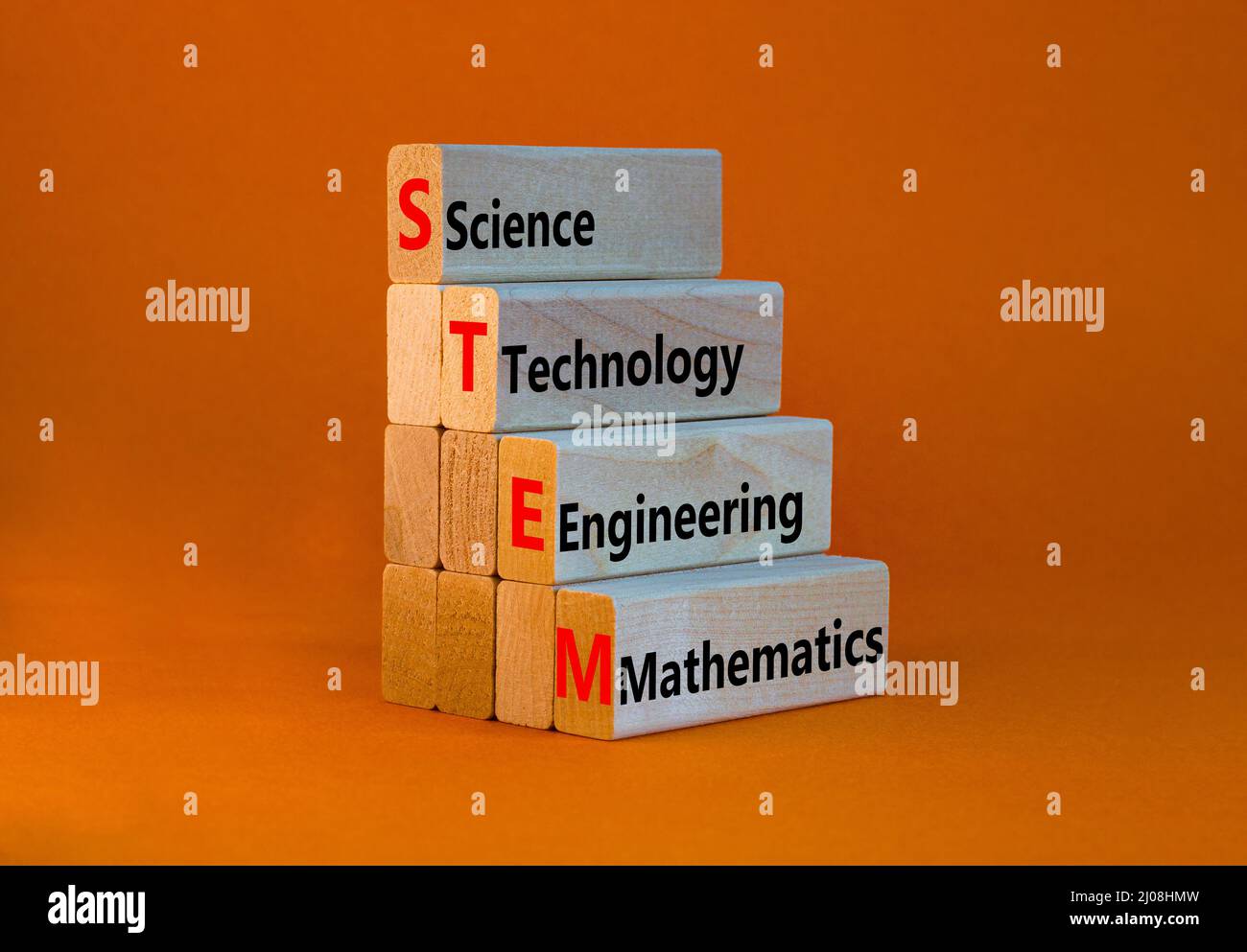 STEM science technology engineering mathematics symbol. Words STEM science technology engineering mathematics on orange background. Business STEM scie Stock Photo