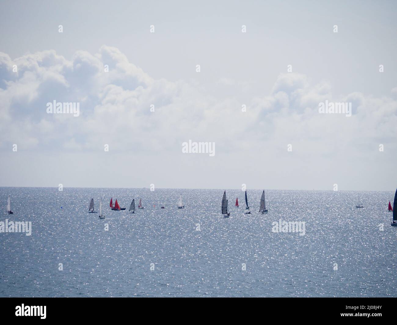 Some small yachts with colourful sails racing in the sea during the summer Stock Photo