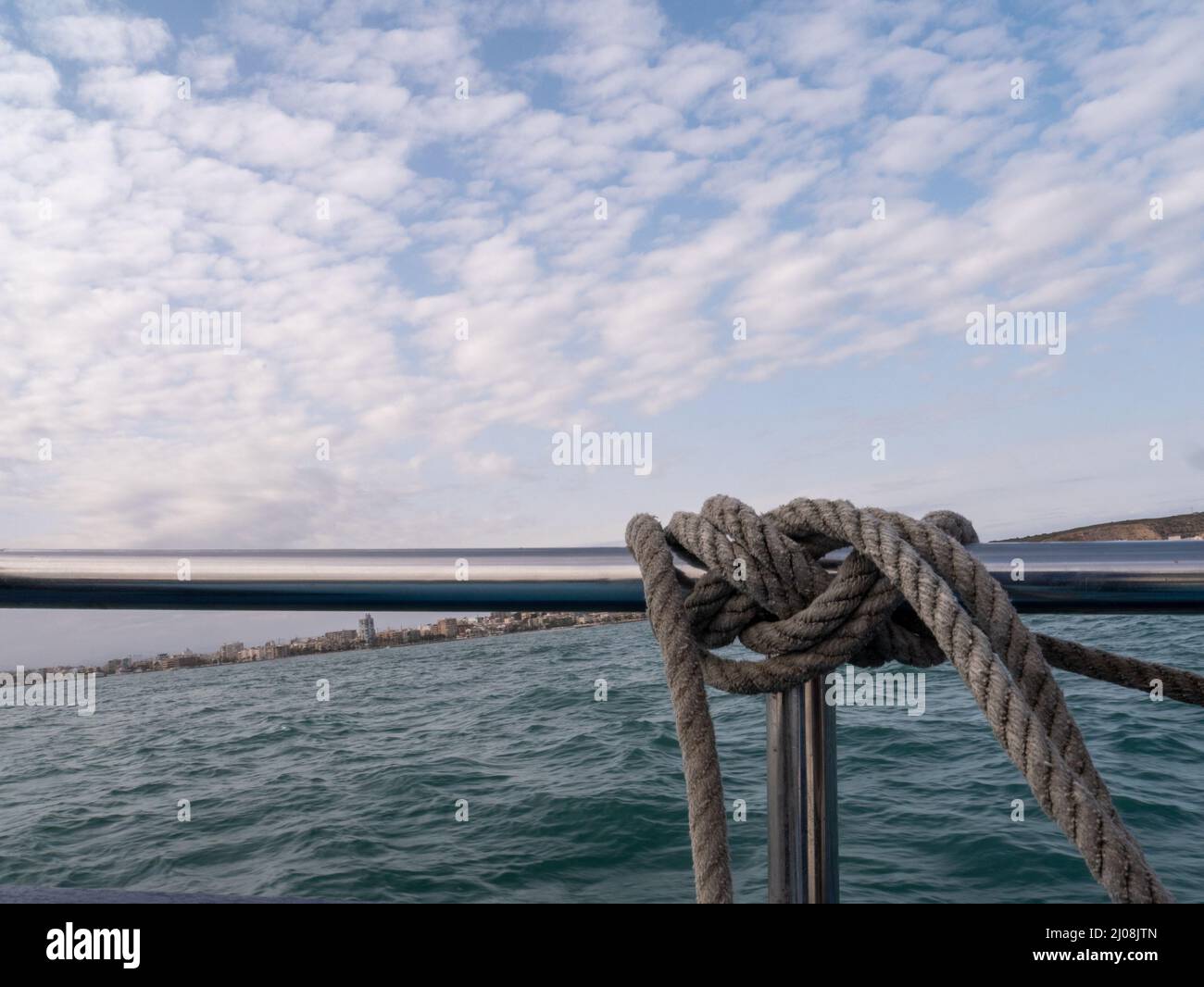A closeup shot of a thick rope tied on a boat railing Stock Photo - Alamy
