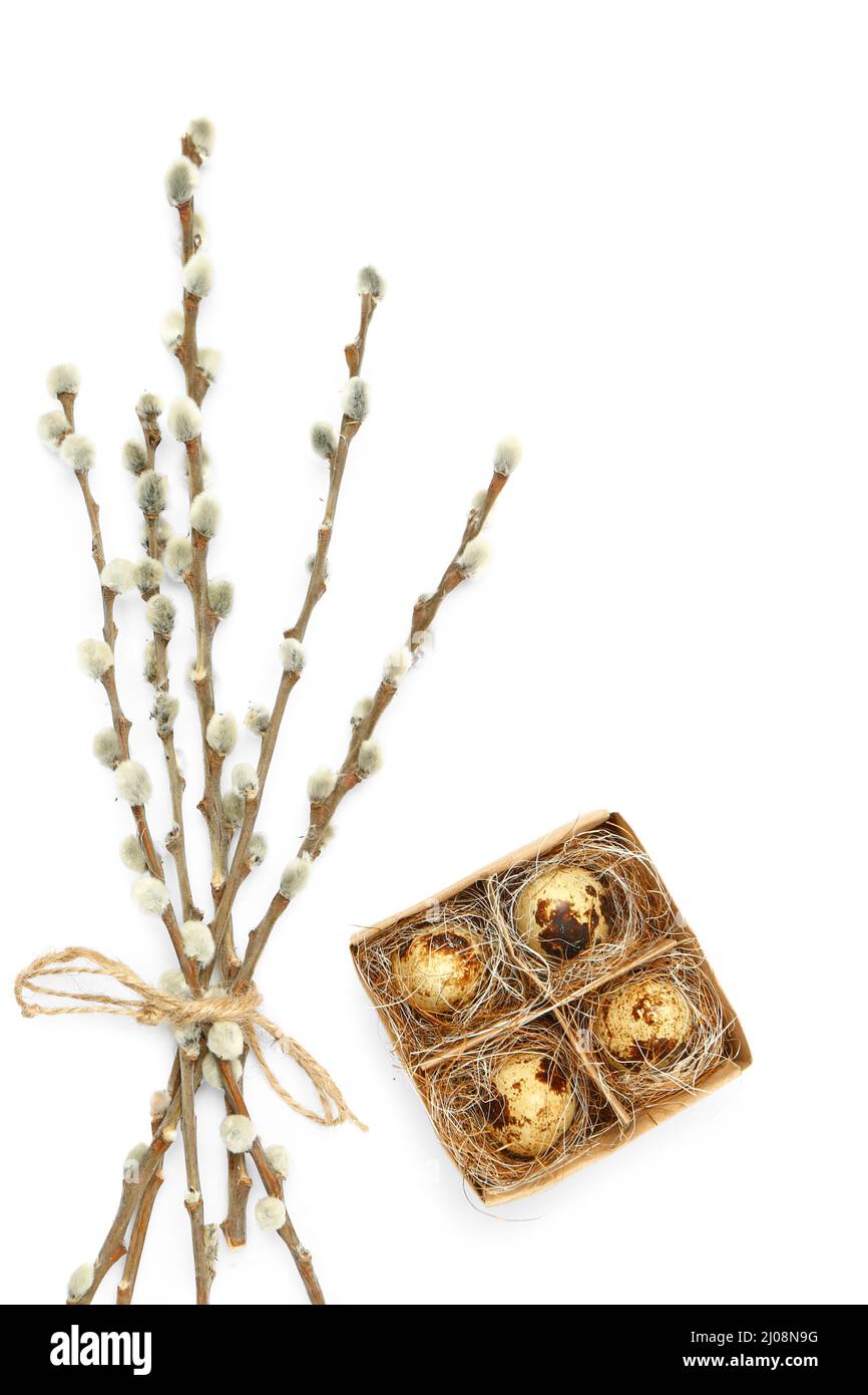 Box with Easter quail eggs and willow branches on white background ...
