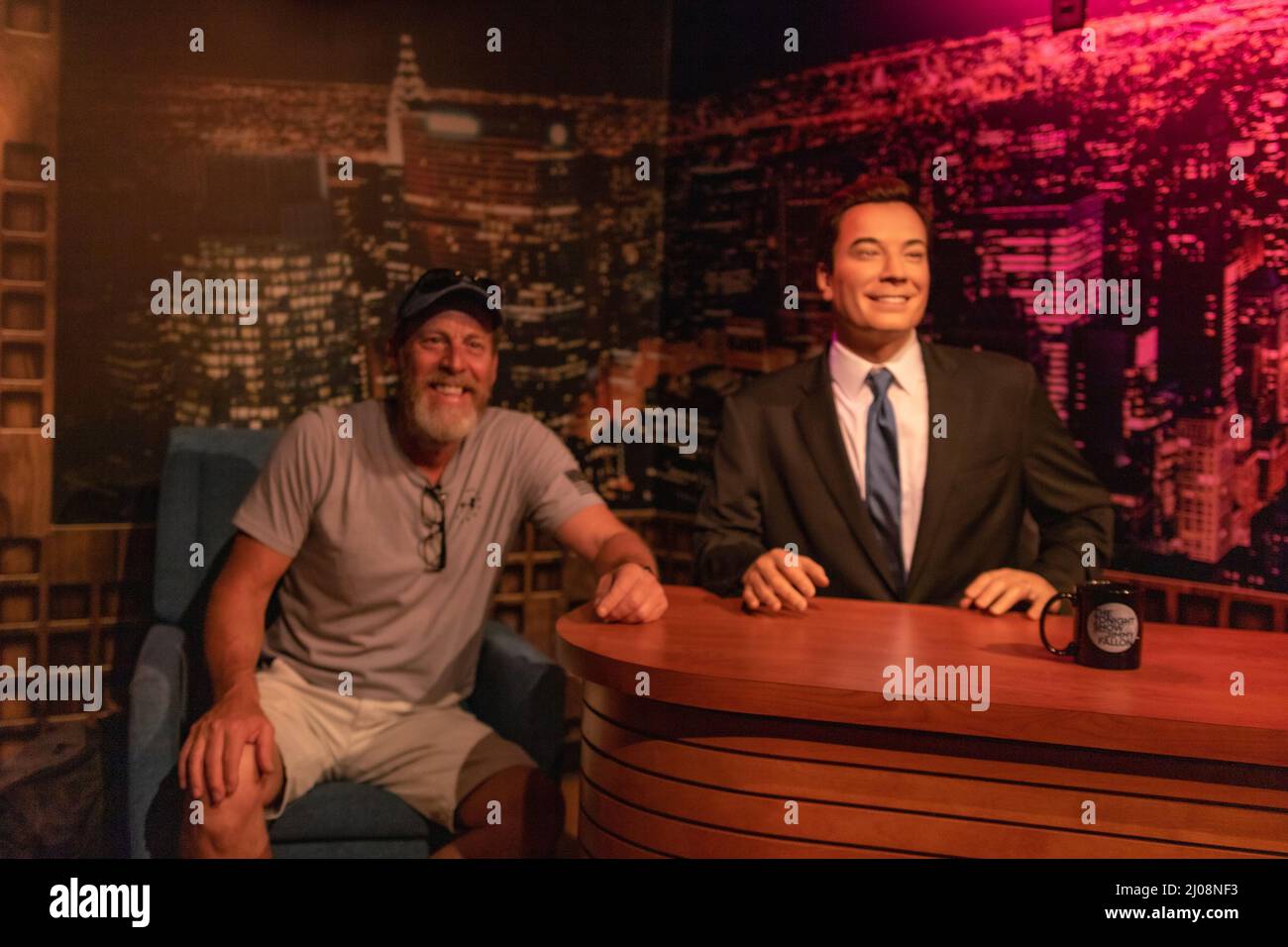 Tourist guy posing with Jimmy Fallon wax figure in Madame Tussauds museum Stock Photo